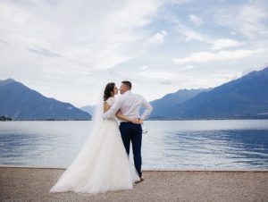 Married couple holding each near at the lake